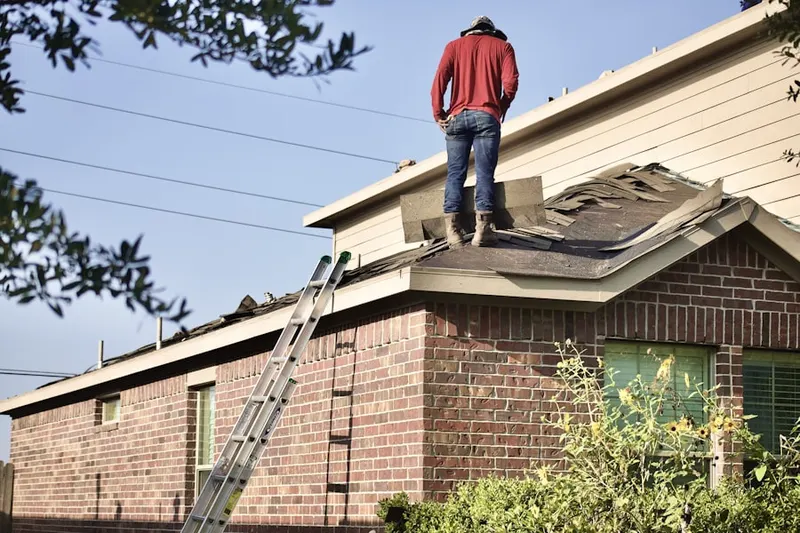 Professional roofer working on a residential roof in Alburtis